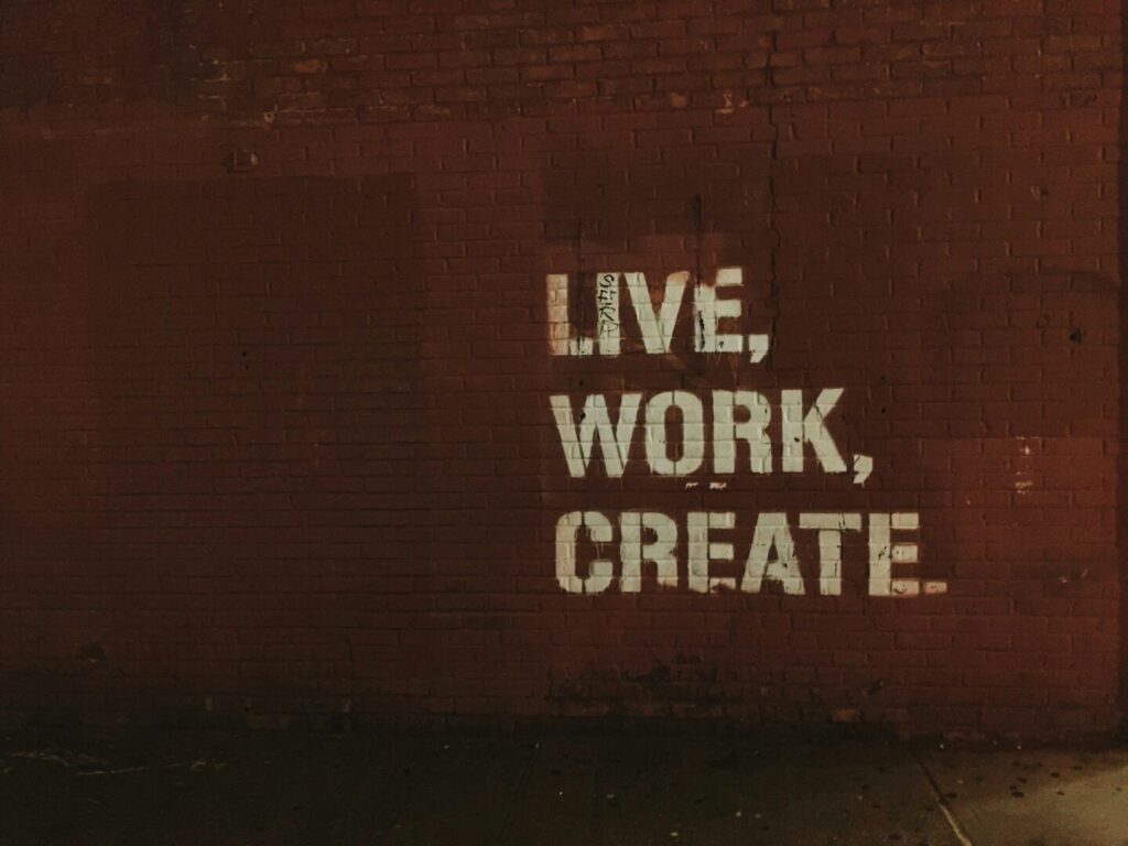 Essential KPIs for a Successful 2025 Marketing Strategy - live work create text on the wall - Josei Creative Agency