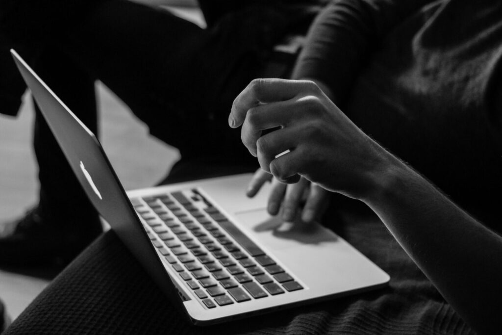 Essential KPIs for a Successful 2025 Marketing Strategy - black and white woman working on a mac laptop - Josei Creative Agency